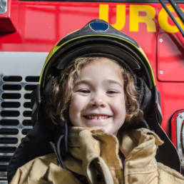 Boy in firefighter helmet