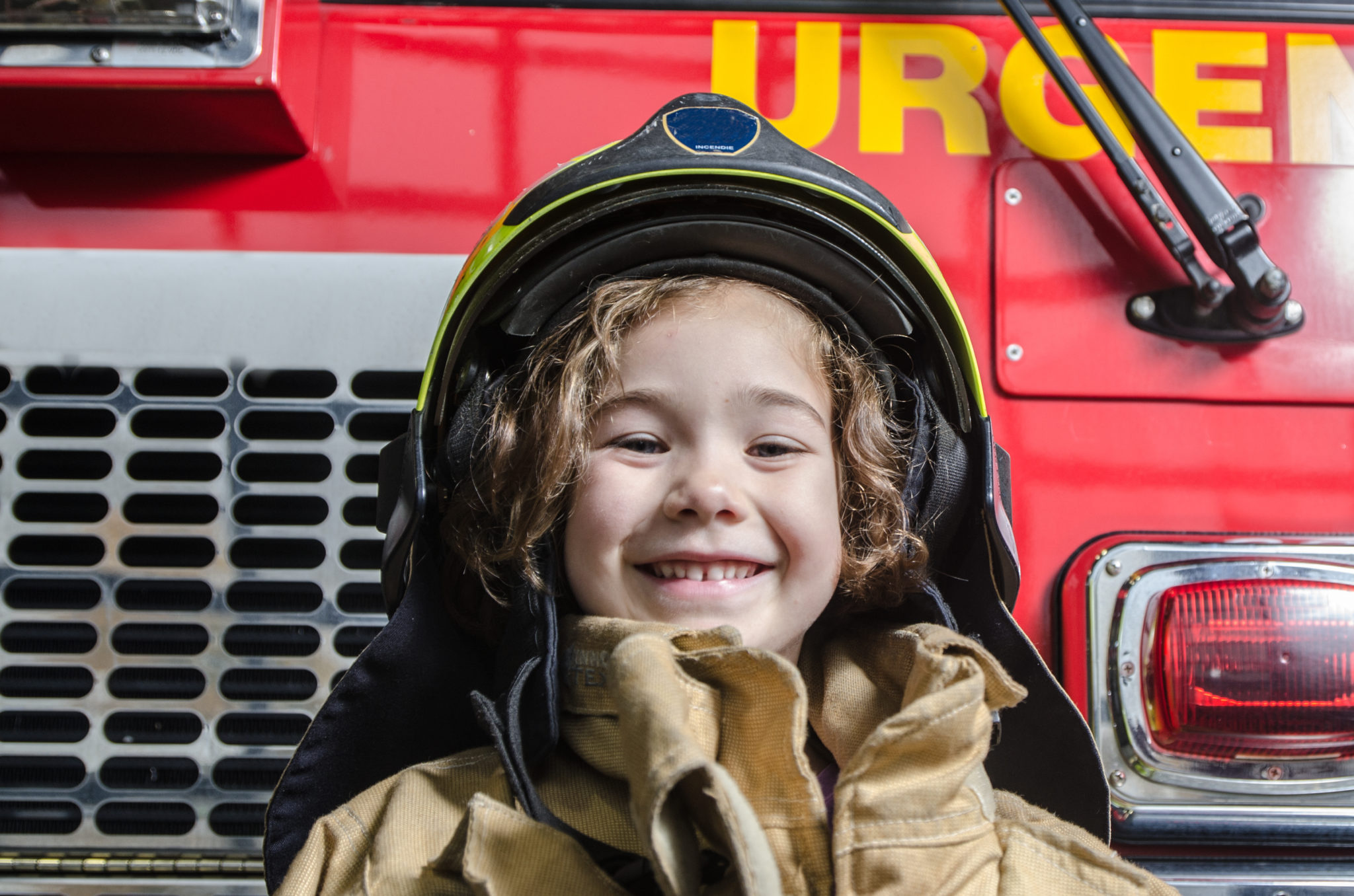 Boy in firefighter helmet