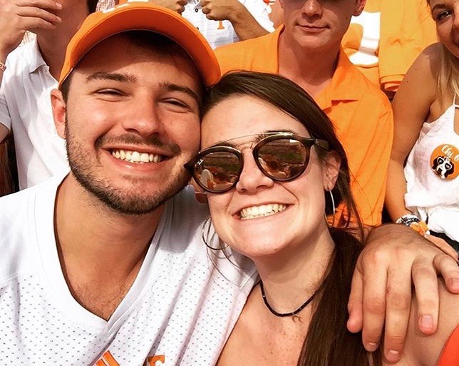 Man and woman smiling at football game