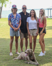 Couple and two grown children with dog